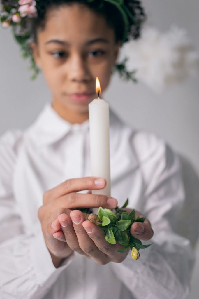 peaceful black girl with burning candle